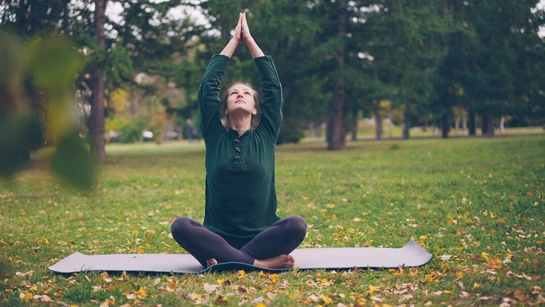 woman doing yoga in park