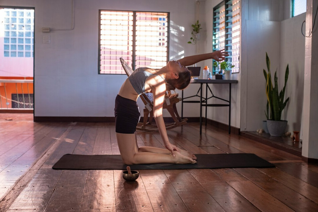 Woman exercising with dumbbells at home