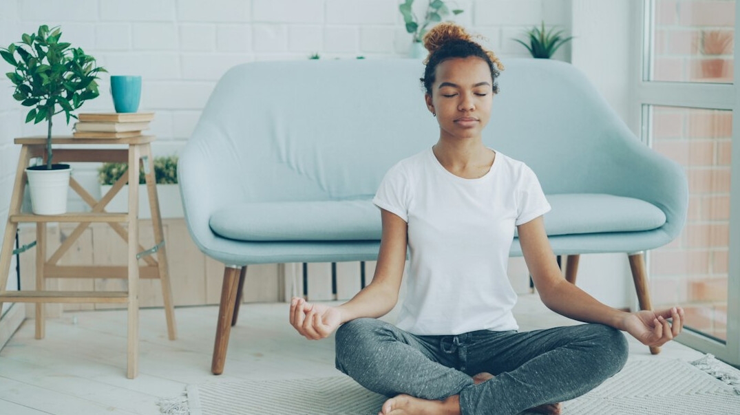 woman meditating indoors